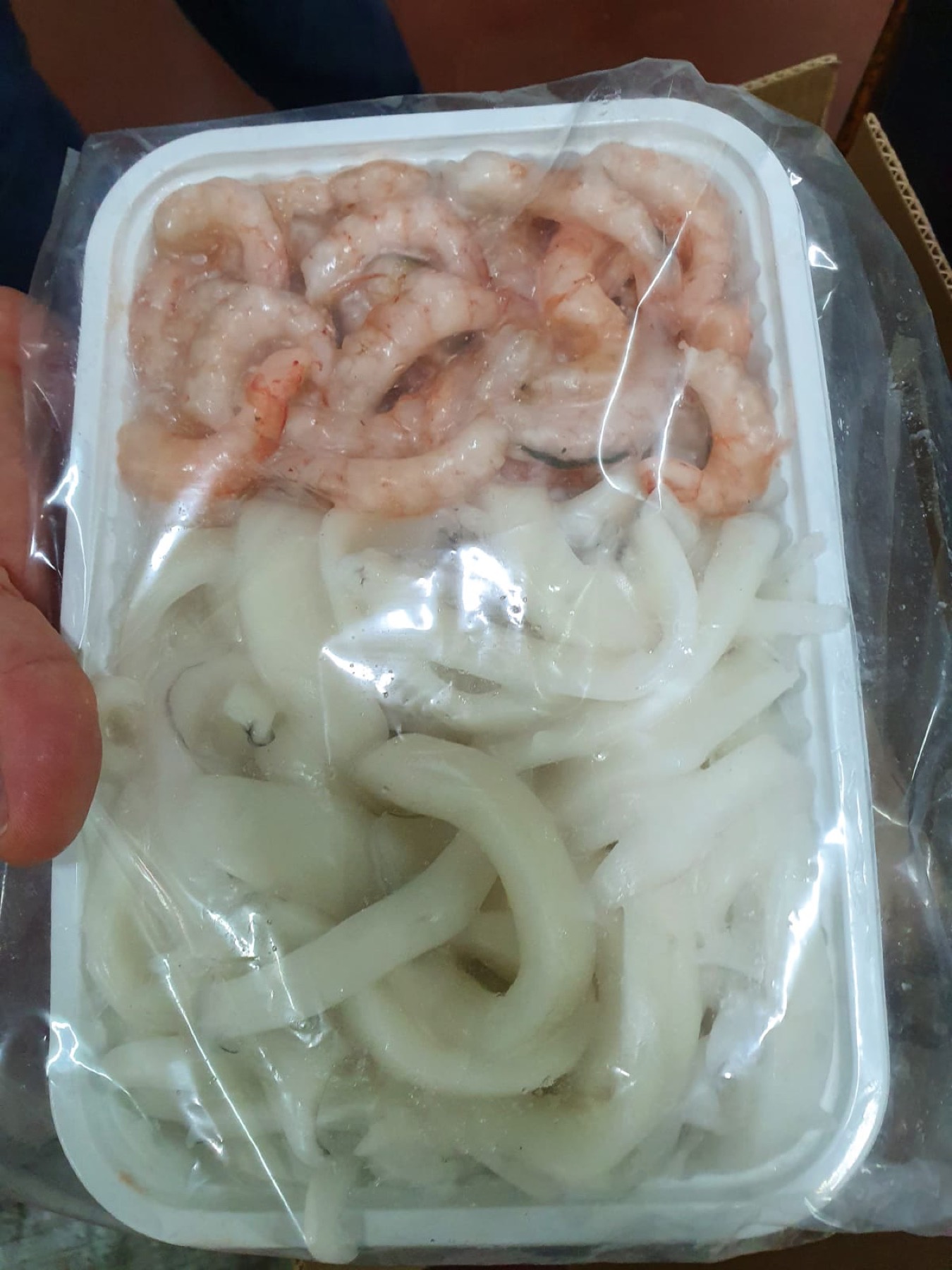 Peeled shrimp and cleaned cuttlefish mix in tray packing